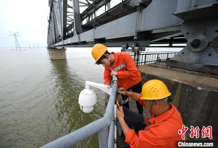 6月24日，南鐵九江橋工段的橋梁工正在九景衢鐵路鄱陽湖大橋上對監(jiān)控攝像頭進行檢修?！『鷩?攝