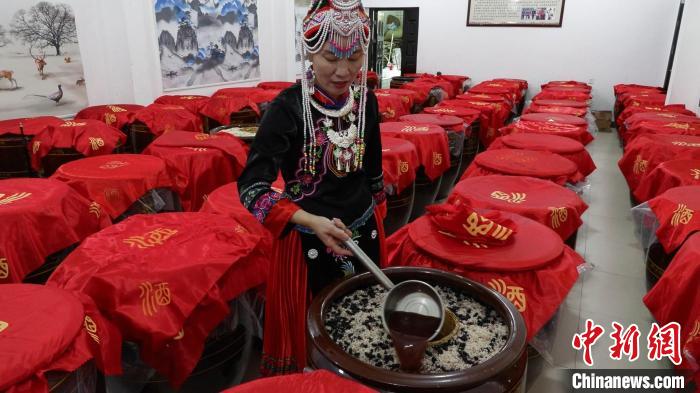 圖為藍(lán)春花在酒廠查看最新釀造的米酒?！∮浾呷A山 攝